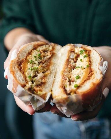 Hot Sandwich Cut in Half Showing Herbs and Sauce